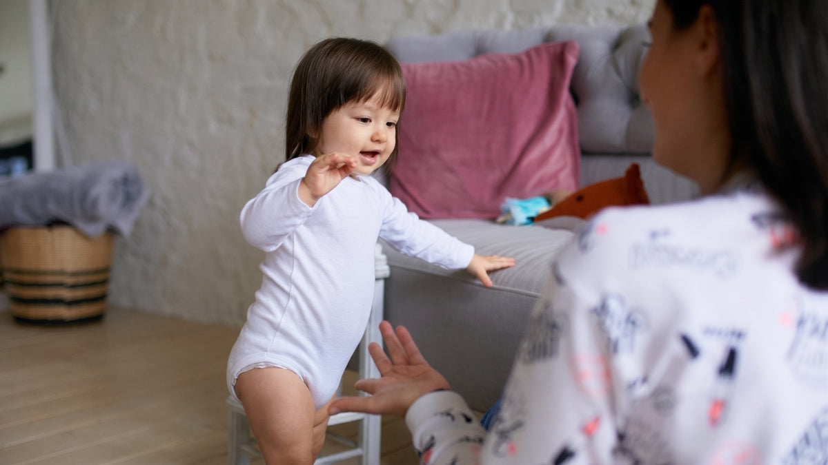 Singaporean toddler sitting on a potty in a bright HDB bathroom during potty training Singapore