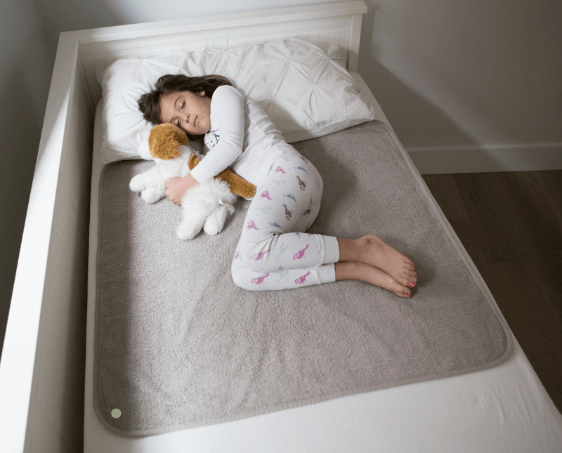 PeapodMats | Girl on Single Bed | Mattress Protector | Waterproof Mat | Sand | SavvyMama