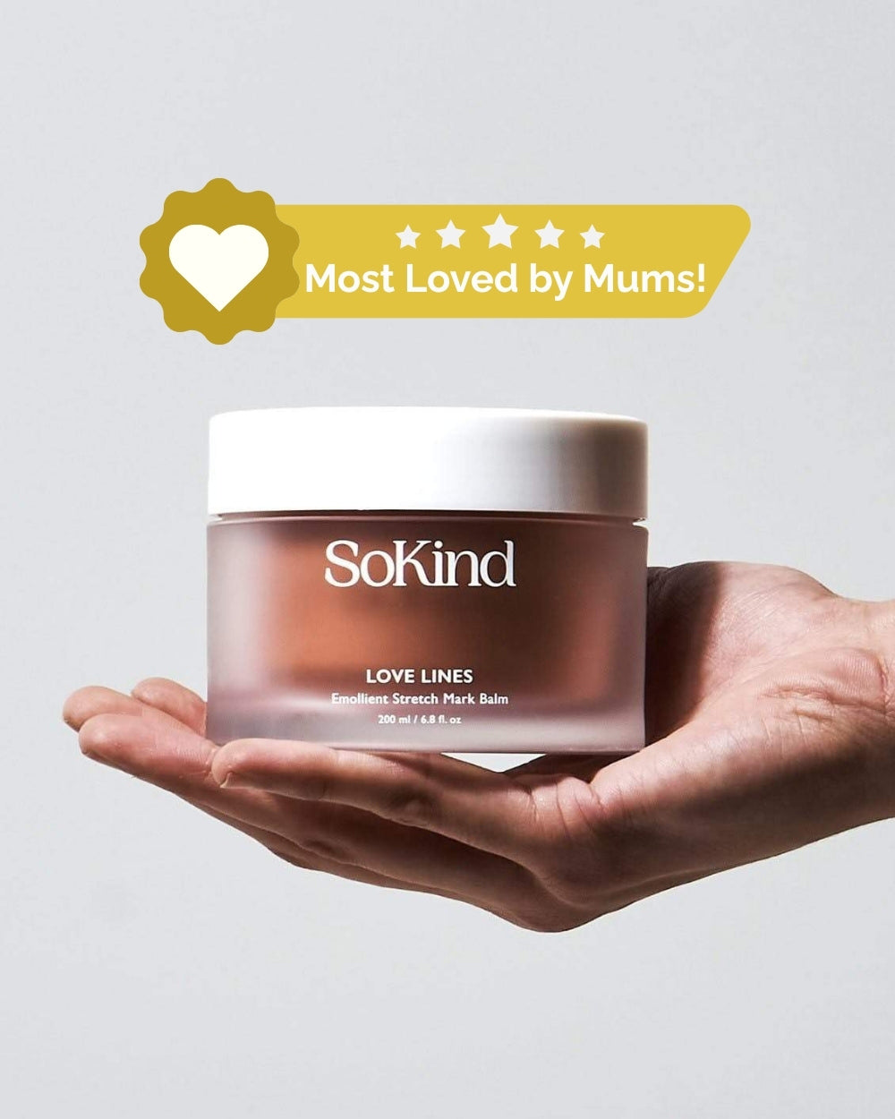 Hand holding SoKind Love Lines stretch mark balm 200 ml beneath a Most Loved by Mums badge