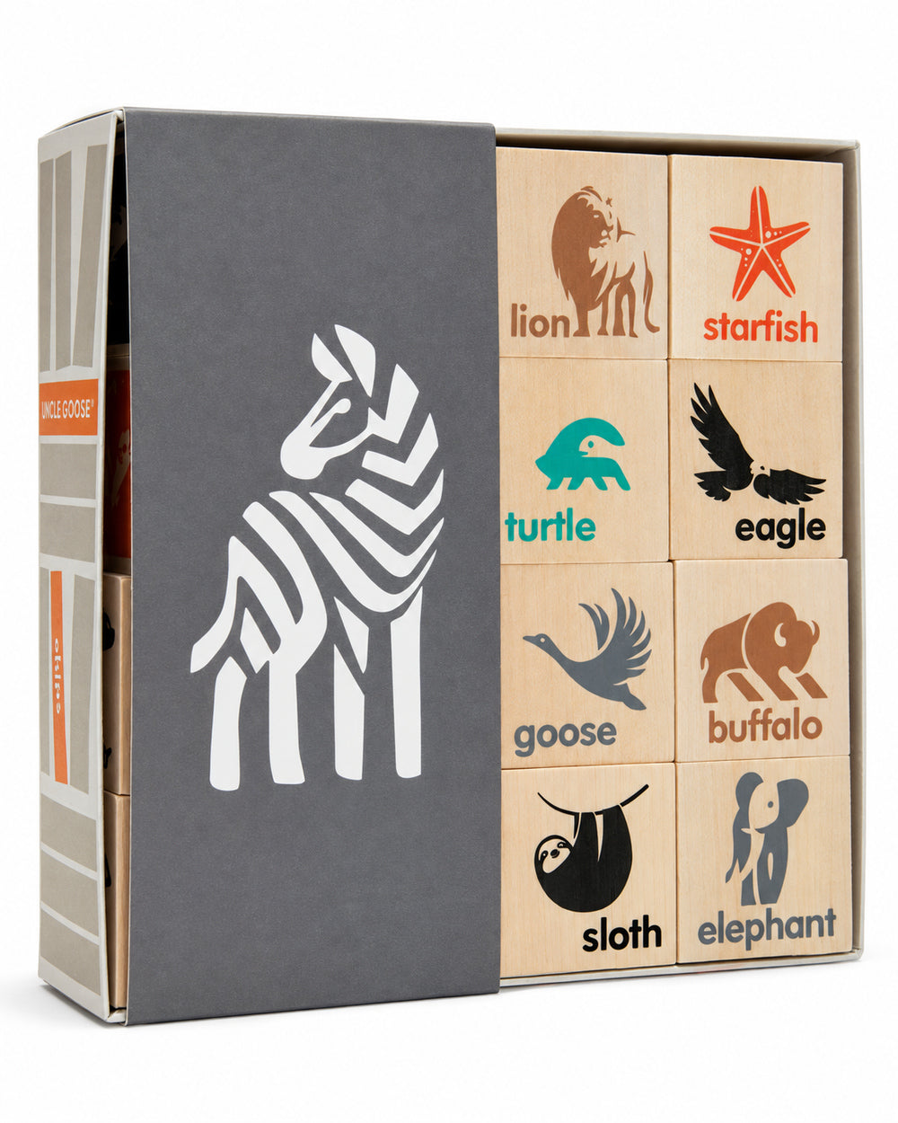 Uncle Goose animal wooden chips in an open box with a grey zebra sleeve