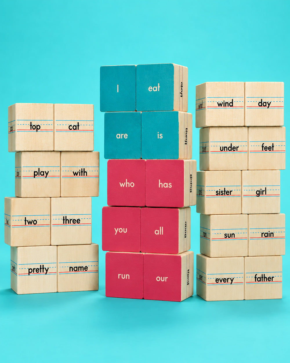Three towers of Uncle Goose Sight Word wooden reading blocks against a turquoise background