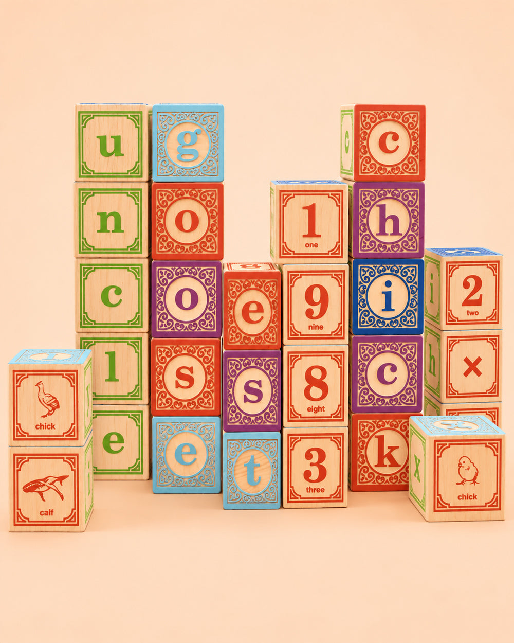 Uncle Goose Classic Lowercase ABC wooden blocks arranged in towers on a peach background